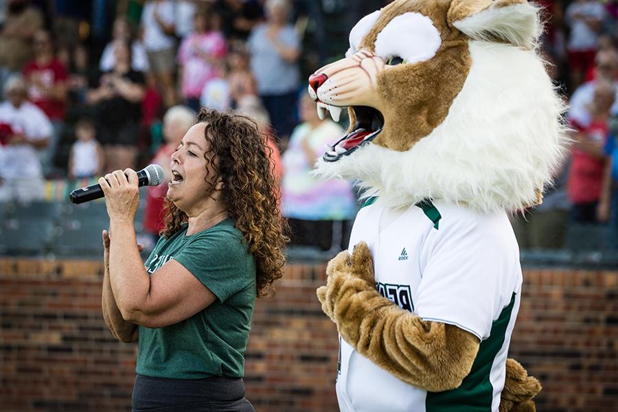 Bobby Bearcat joined Northwest alumna Polly Havard as she sang the national anthem during last year's Northwest Night at the St. Joseph Mustangs. (Photo by Lauren Adams/Northwest Missouri State University)